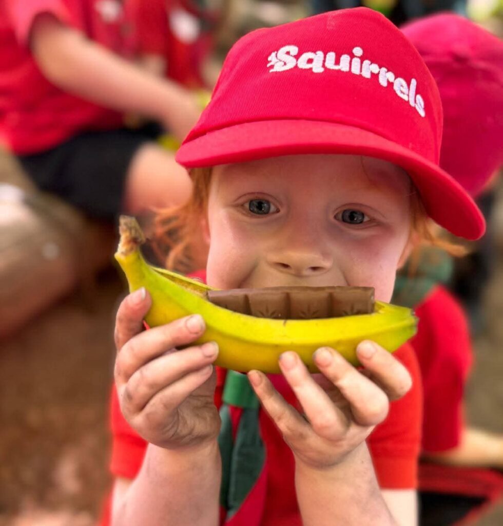 Squirrel scout eating bananas and chocolate